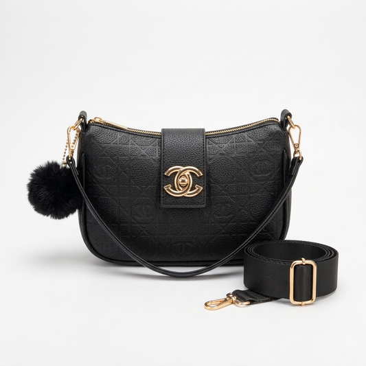 Black crossbody bag with gold-tone details, pom-pom, slim shoulder strap and wide adjustable crossbody strap