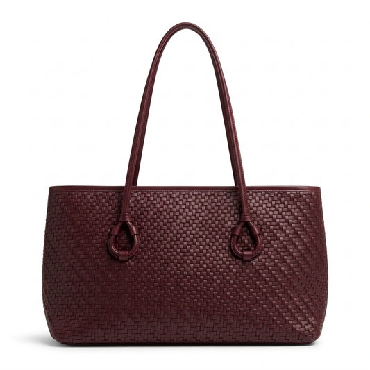 Burgundy tote with a shorter body and long handles on a white studio background
