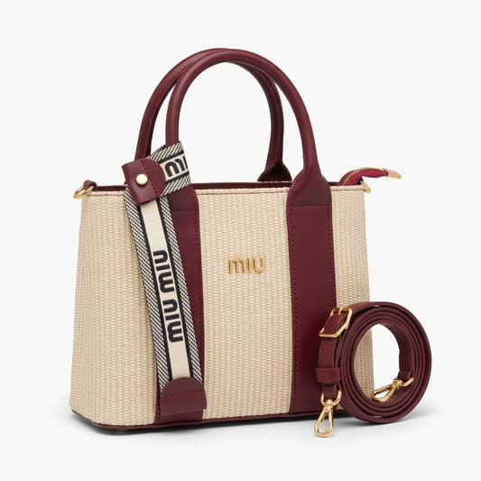 Compact cream woven bag with burgundy trim and crossbody strap beside it