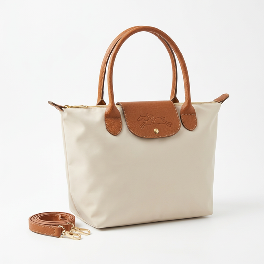Paper-colored large bag with unwrapped tan handles and strap neatly placed beside it on a white background